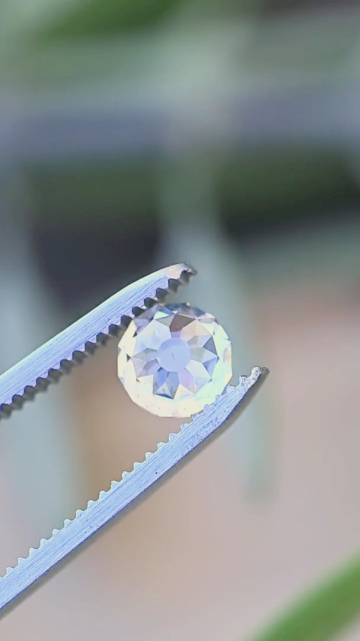 1.68 carat Mughal cut diamond rotating between jeweler’s tweezers, showing its unusual radial faceting and sculptural profile.