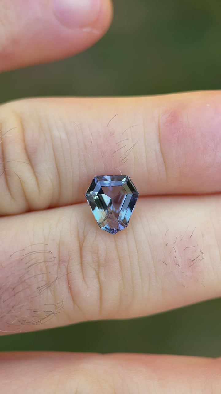 Reflecting video of 2.75ct Tanzanite in hand, showing crisp step cut facets and vibrant teal, green, and purple shifts