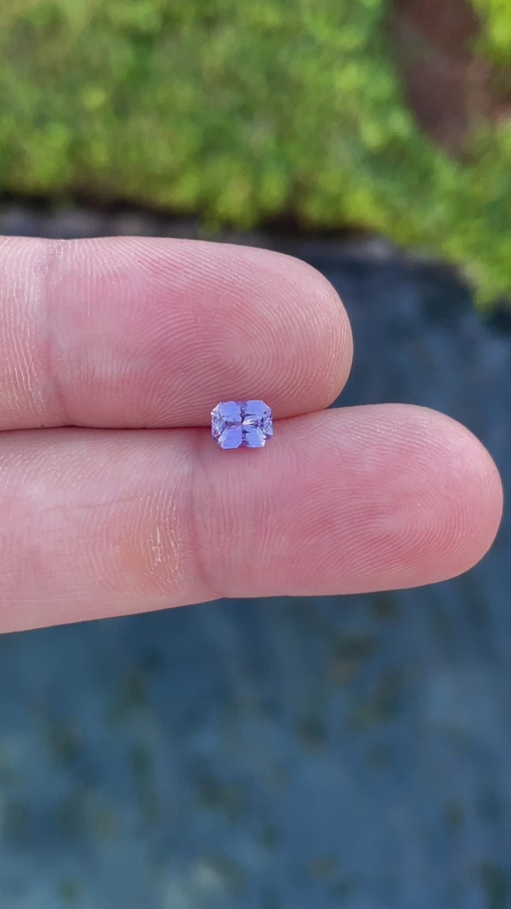 Close-up video of a 1.05 carat radiant cut pink and purple sapphire, capturing its sparkling facets and untreated natural beauty from Sri Lanka.