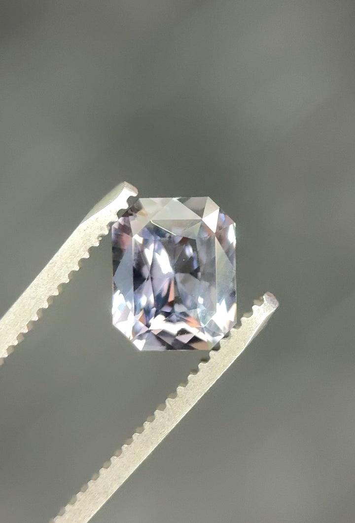 Close-up video of untreated color change sapphire from Sakaraha, Madagascar, 2.53 carats, precision radiant cut with vibrant steely blue and purplish-grey hues.