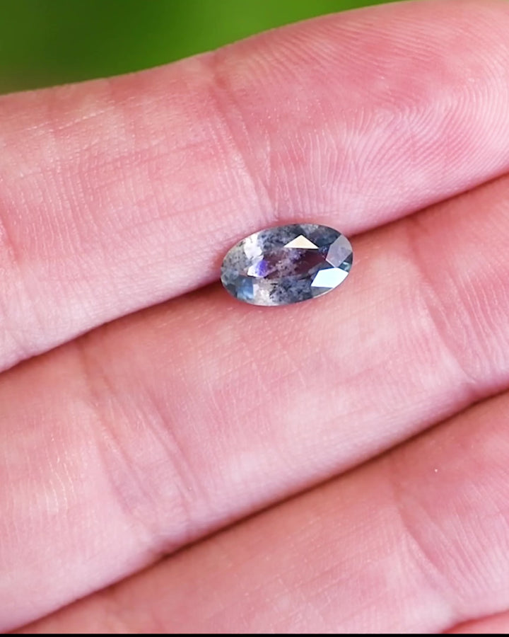 Blue 1.24 carat sapphire in hand