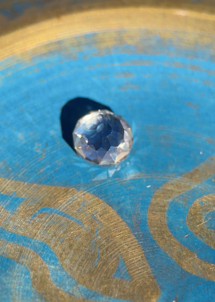 Video of a 0.80 carat Fancy Light Brown C3 Mughal Cut diamond being rotated on a blue surface to show brilliance, antique faceting, and VVS2 clarity; untreated South African diamond with very strong blue fluorescence.