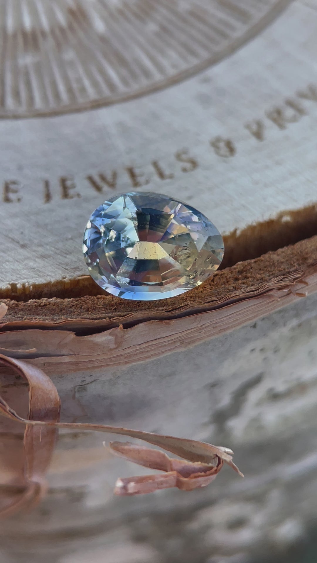 A 1.95-carat Parti Yellow and Blue Sapphire showcasing its unique color blend and brilliance in motion. This unheated pear-oval gem, ethically sourced from Sri Lanka, is displayed with dynamic angles to highlight its clarity and craftsmanship.