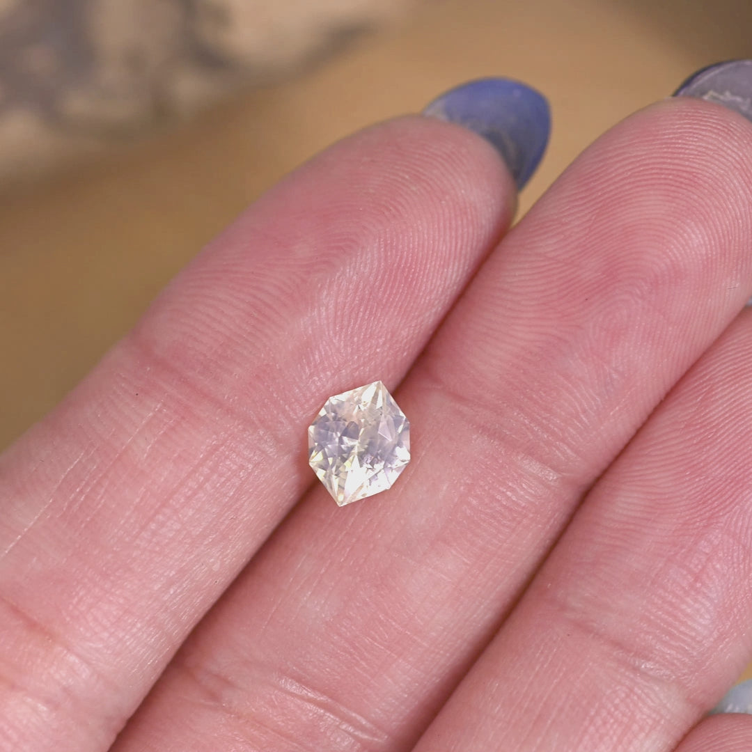 Rotating loose pastel green yellow sapphire custom geometric marquise cut from Sri Lanka revealing pastel tones and sparkle as the gemstone turns in light.