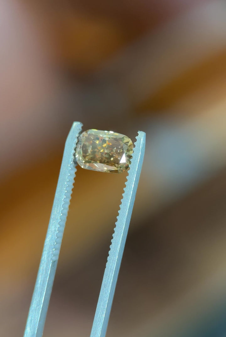 Video of a 2.20 carat fancy brown diamond from Argyle Mines, Australia, rotating under natural light. The elongated cushion cut reveals depth of color, strong blue fluorescence, and natural brilliance of this untreated diamond.