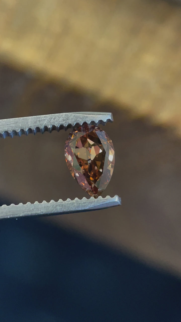 360-degree video of a Fancy Dark Orangy Brown pear diamond, highlighting its remarkable VVS1 clarity and deep orangy-brown hues.