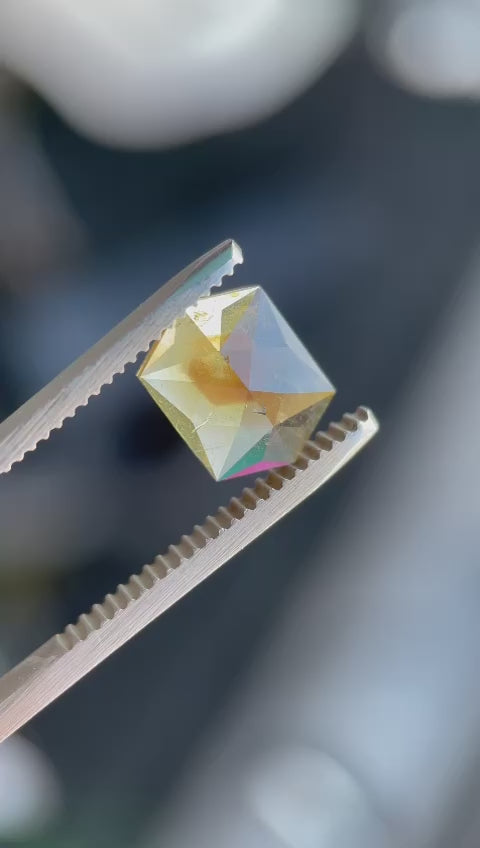Video highlighting the unique features of a 3.12-carat sapphire with a custom hexagon rose cut, showcasing its amber, orange, mauve, and brown hues. The gemstone is rotated under natural light, emphasizing its brilliant facets and origin from the Umba River in Tanzania, with no treatment.