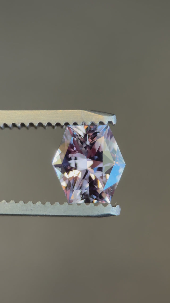 1.60ct hexagonal sapphire shifting from purple mauve to grey under directional light, precision cut from Madagascar