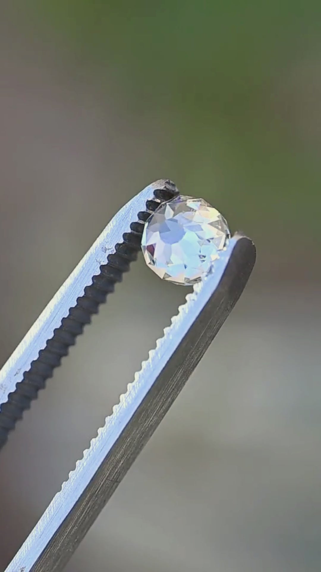 1.11 carat South African Mughal cut diamond rotated between jeweler’s tweezers, revealing its depth, near-round outline and broad antique-inspired faceting.