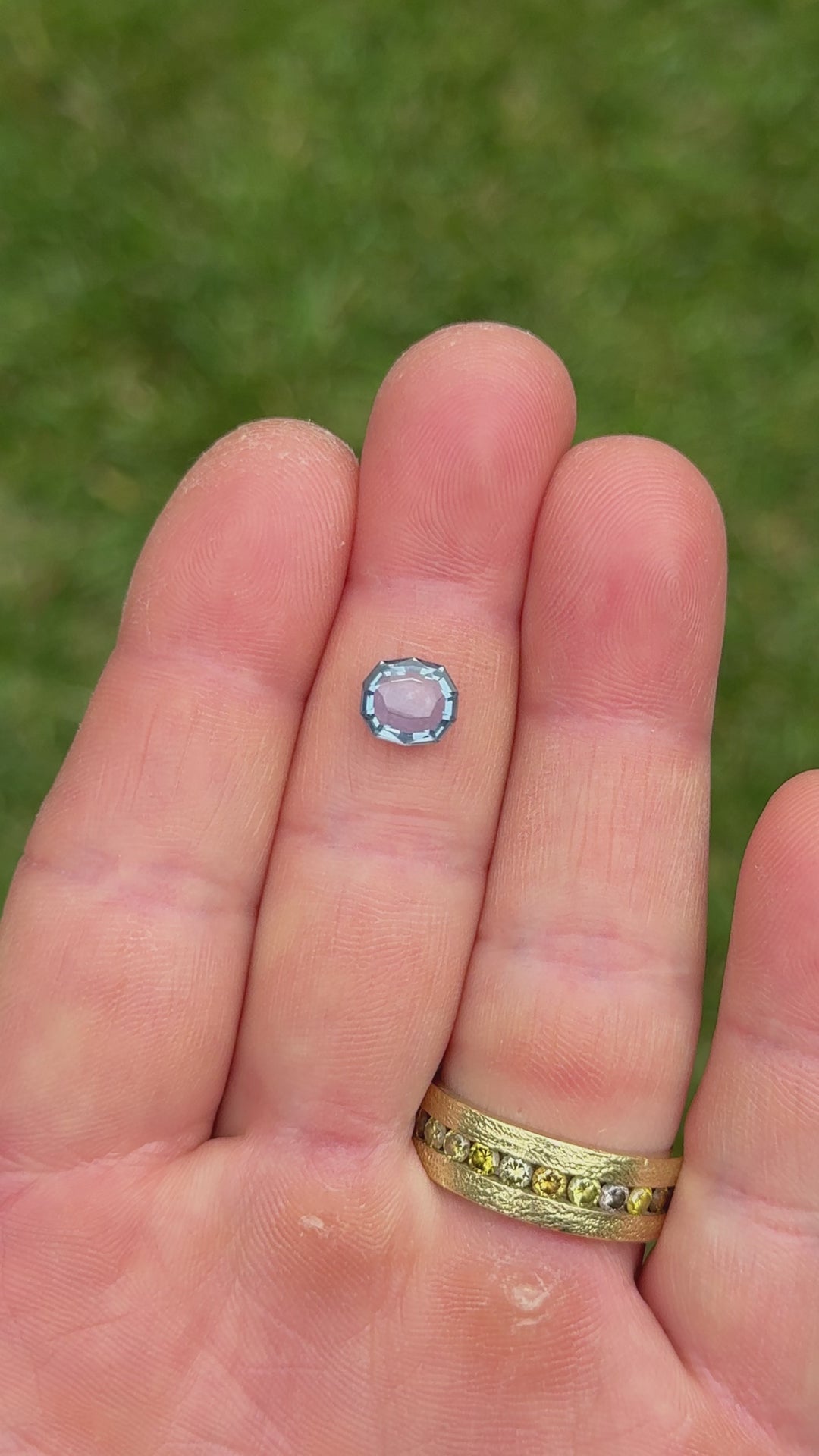 Close-up video of 2.08ct Montana sapphire in hand, capturing the natural color transition from violet to blue in daylight.