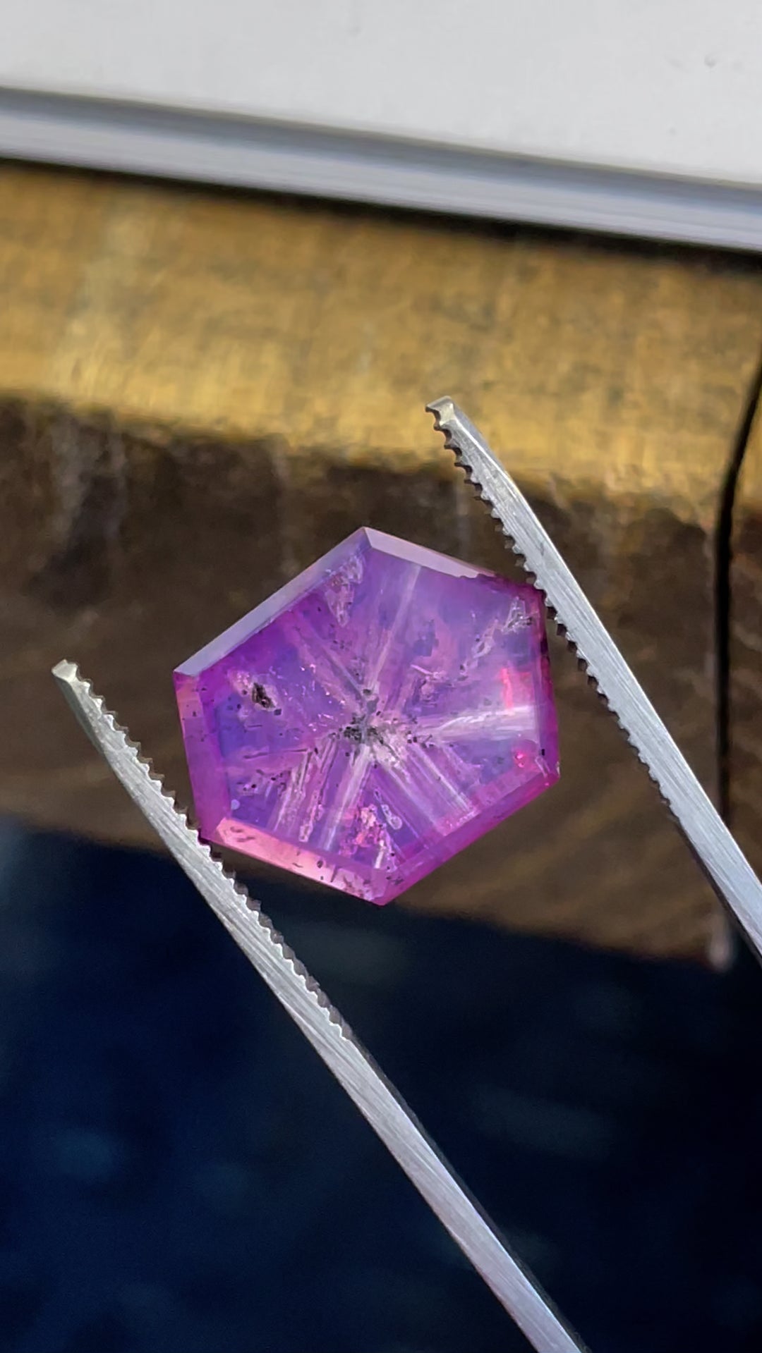 A detailed high-resolution video capturing the brilliance of a 19.62-carat hexagon-cut sapphire, emphasizing its clarity and natural starburst pattern.