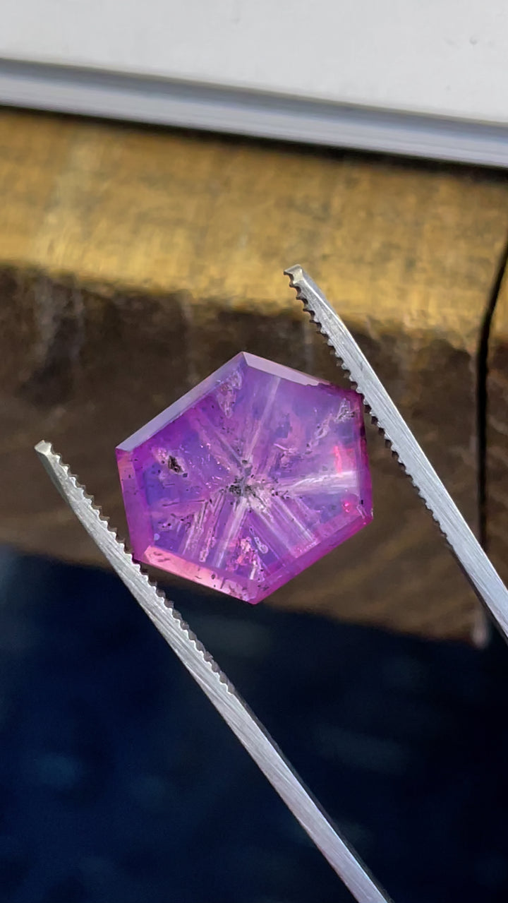 A detailed high-resolution video capturing the brilliance of a 19.62-carat hexagon-cut sapphire, emphasizing its clarity and natural starburst pattern.