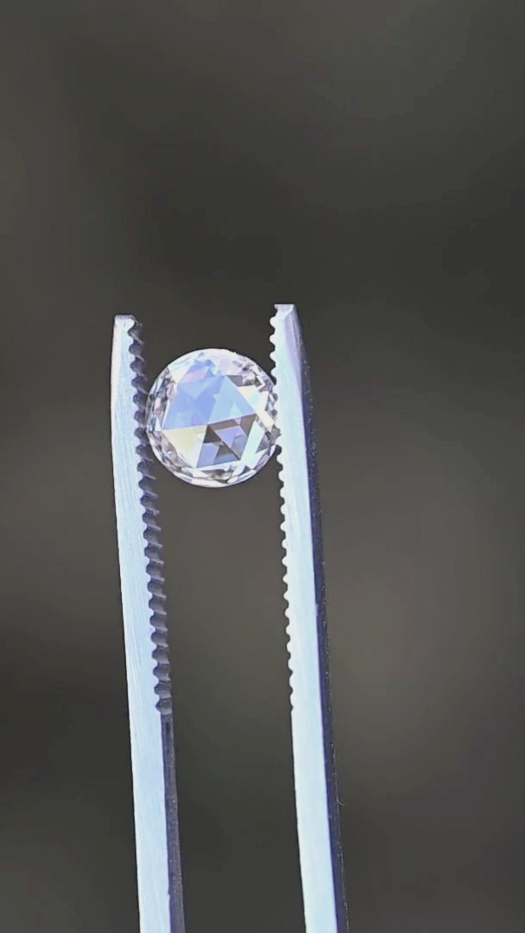 This rotating view showcases the diamond's antique rose-cut faceting, balanced round outline, and subtle blush champagne color as it catches changing light from multiple angles.
