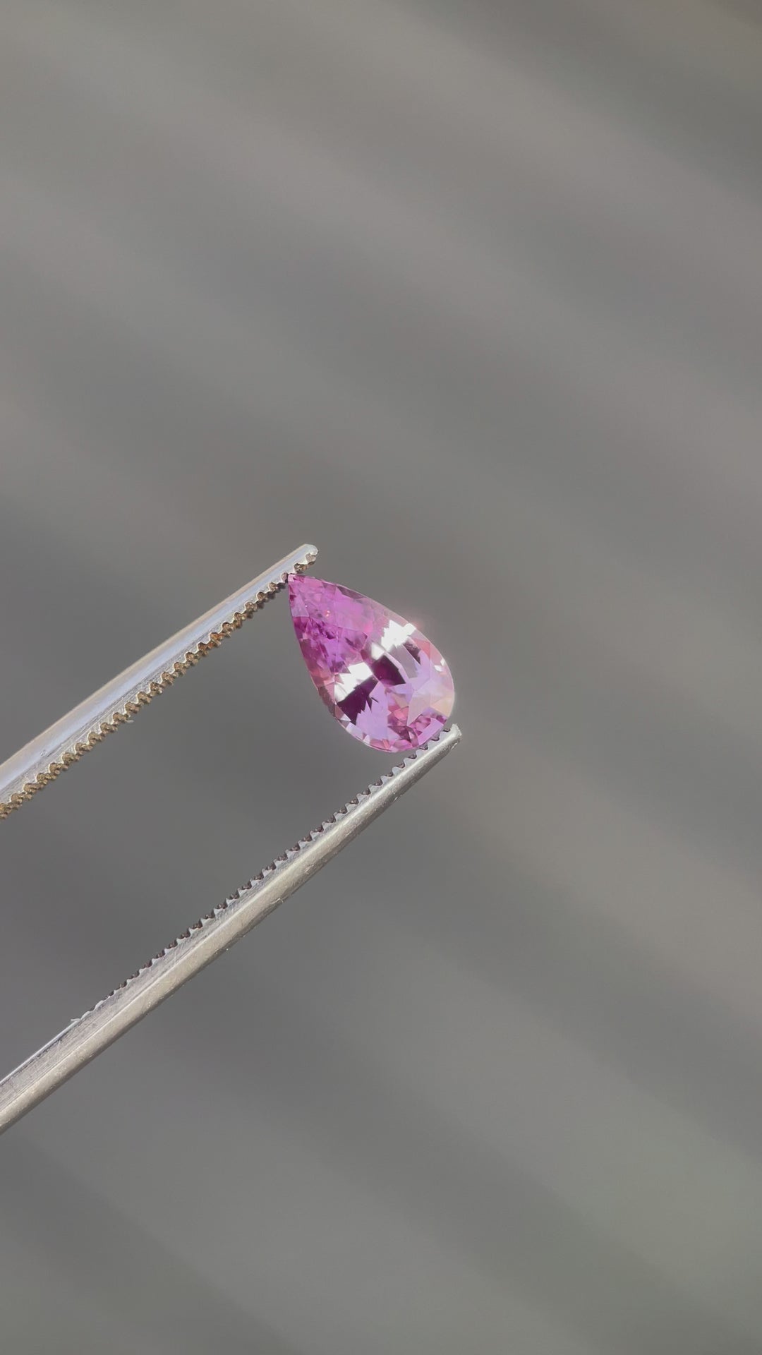 A 360-degree view of a 1.54-carat purple sapphire in a mix brilliant pear cut, showing the gemstone's clarity, color, and expert craftsmanship. The sapphire is natural, untreated, and originates from Sri Lanka, revealing its purple allure from every angle.