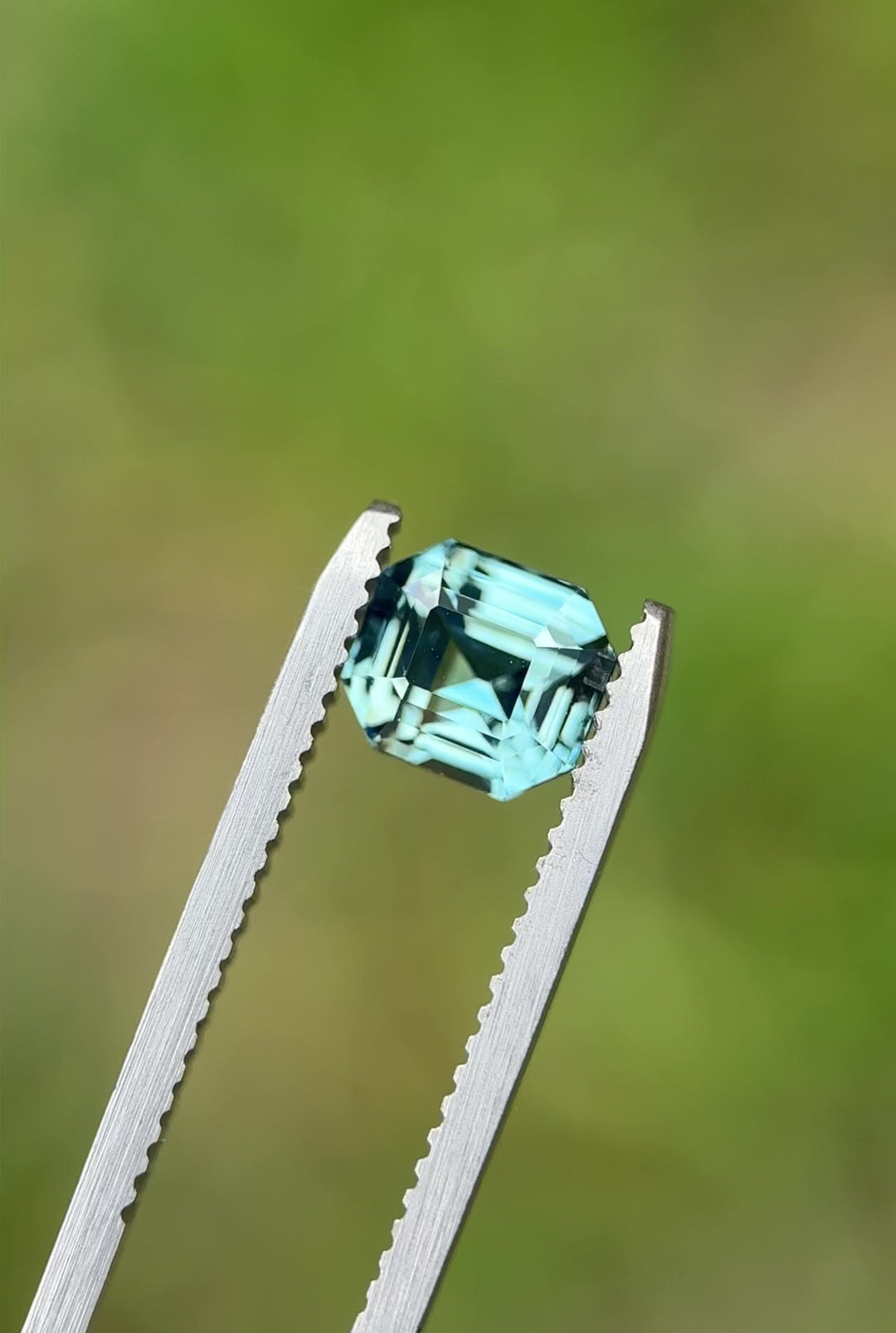 Rotating video of a 2.14-carat sky blue sapphire from Madagascar in emerald cut, highlighting its natural sparkle and step facets under natural light.