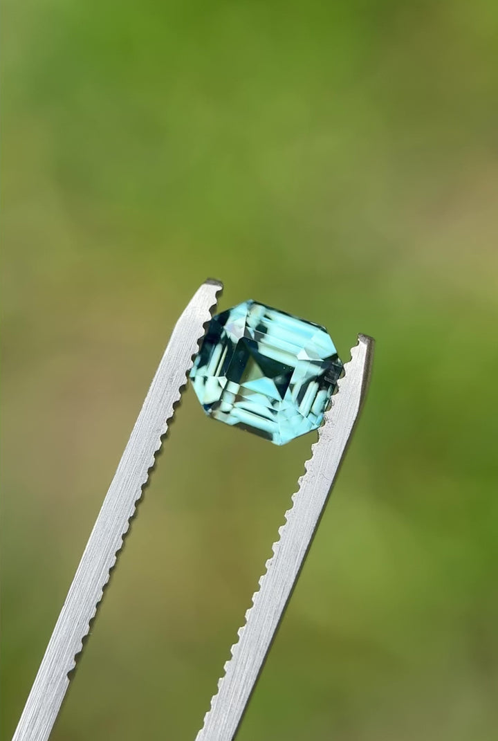 Rotating video of a 2.14-carat sky blue sapphire from Madagascar in emerald cut, highlighting its natural sparkle and step facets under natural light.