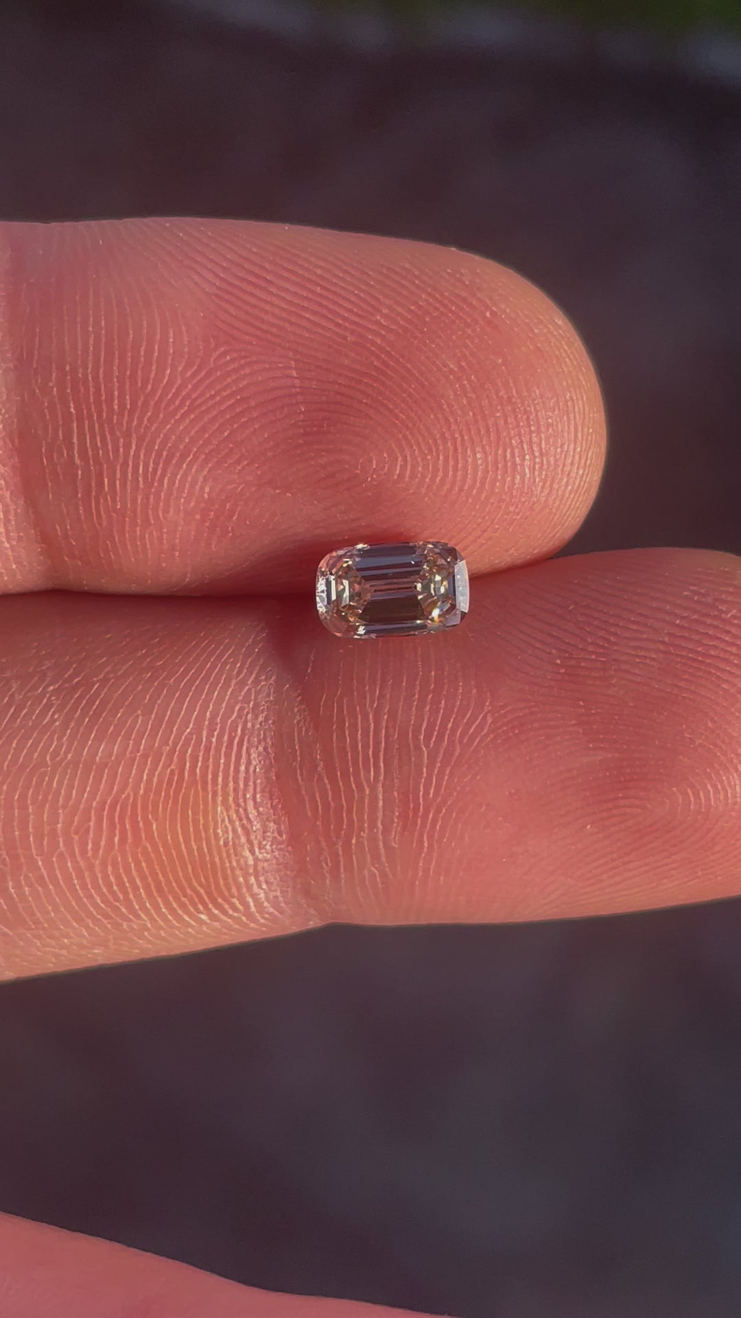 A rotating view of the South African 1.02-carat cushion-cut diamond, displaying its light fancy yellowish brown hues and SI1 clarity.