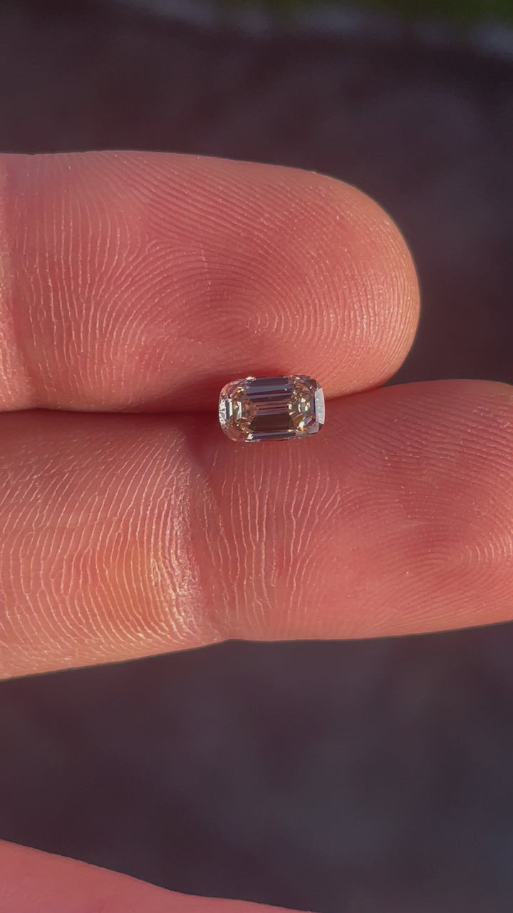 A rotating view of the South African 1.02-carat cushion-cut diamond, displaying its light fancy yellowish brown hues and SI1 clarity.