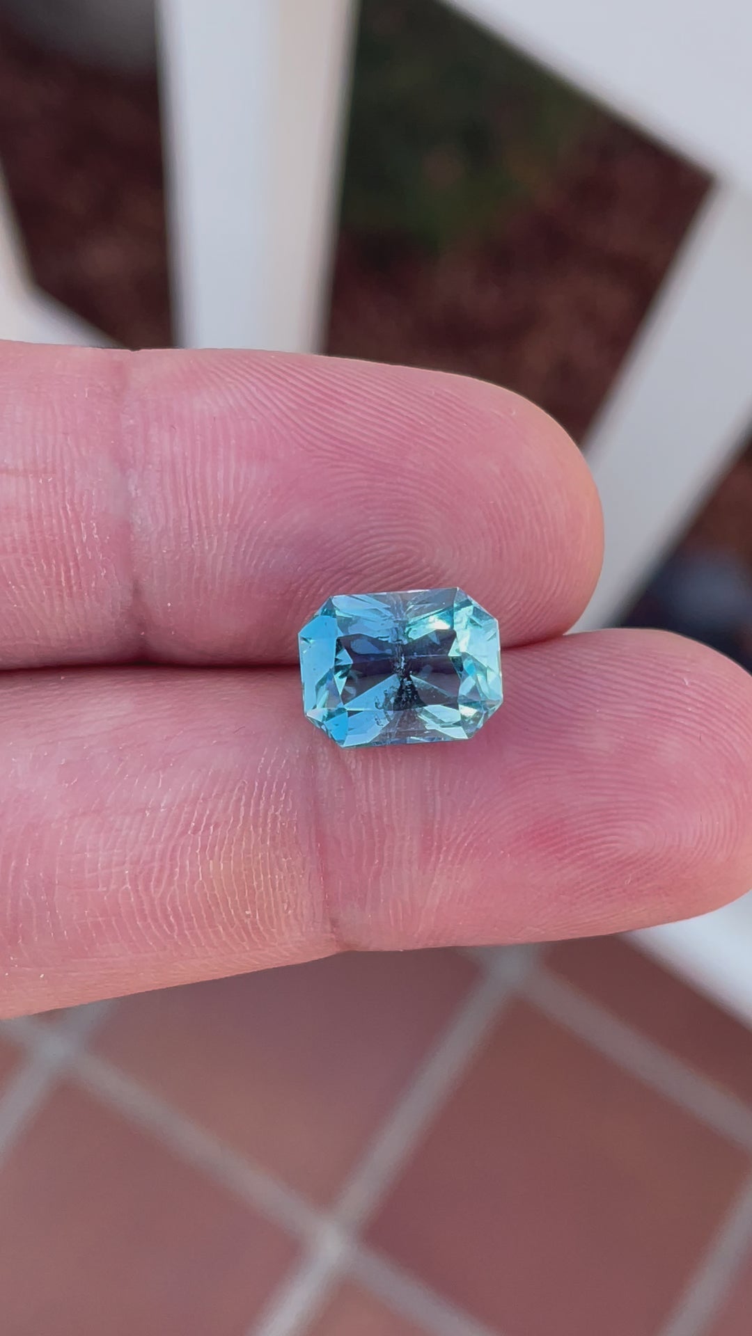 Detailed presentation of a 4.63-carat aquamarine from Nigeria, showing off its octagon radiant cut and mesmerizing double blue color. The video captures the gemstone under various light settings to demonstrate its exceptional clarity and captivating sparkle.