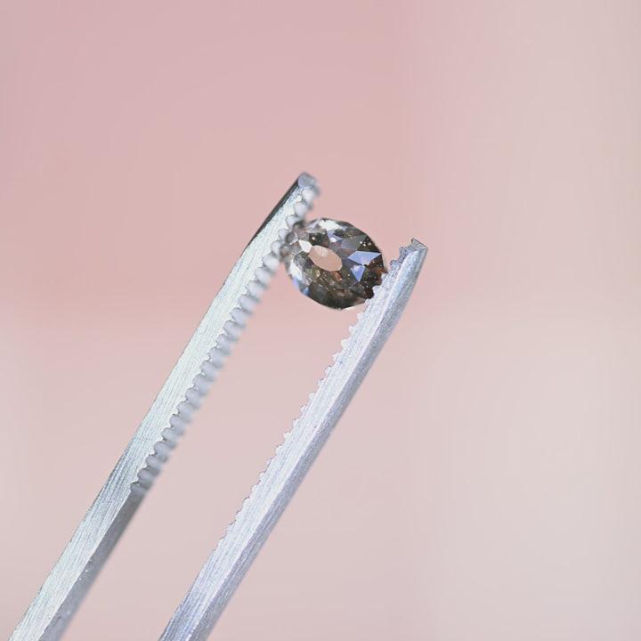 Loose fancy light brown Mughal cut champagne diamond from South Africa rotating in tweezers, showcasing its character, sparkle, and antique-style cut.