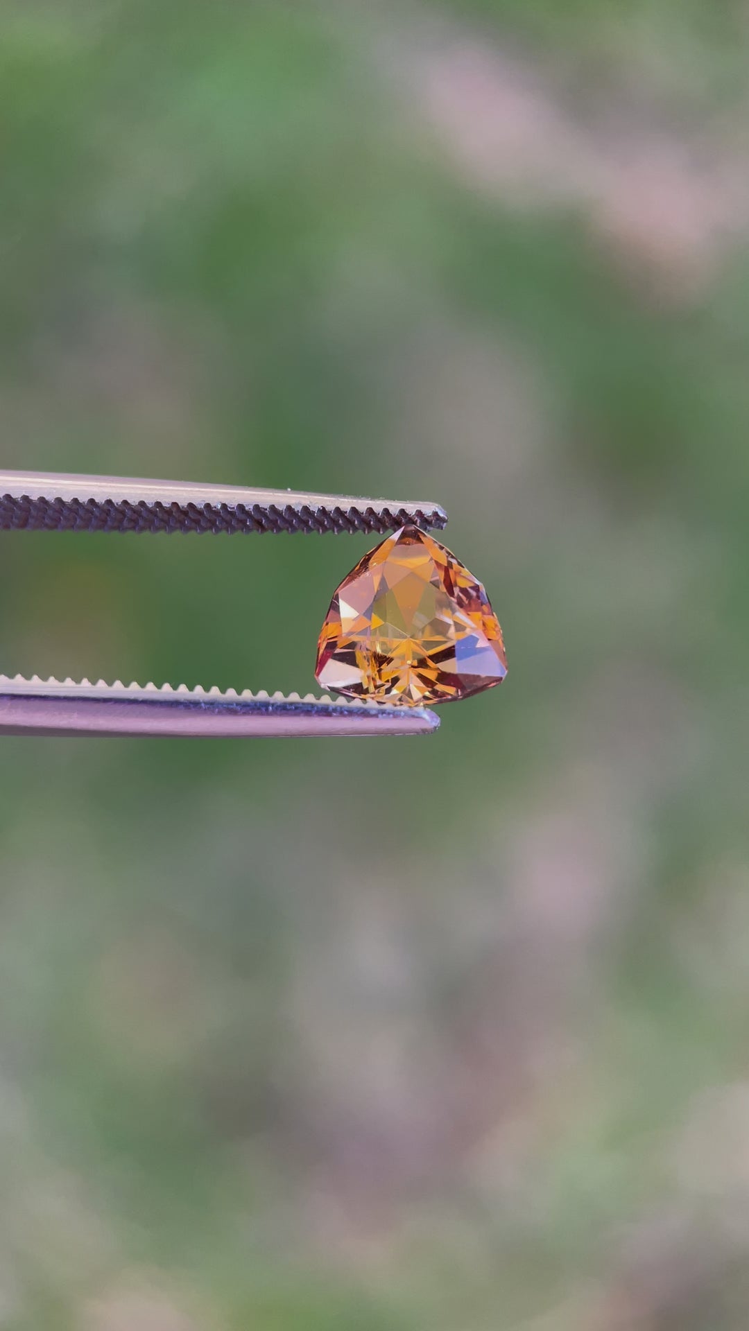 Detailed Video of a Custom Trilliant Cut Tanzanite Gemstone in Vivid Peach Orange Color, Weighing 2.01 Carats, with Dimensions 8.06 x 8.14 x 5.32 mm, from Merelani Hills, Arusha Region, Tanzania - No Treatment