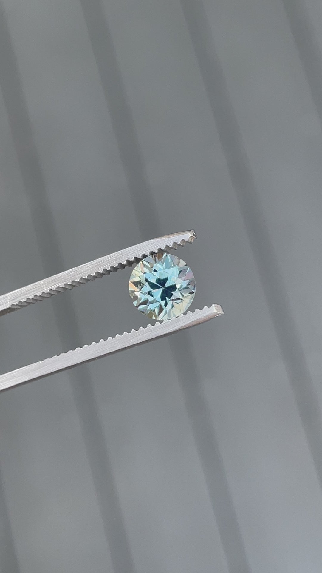 360-degree video of a 2.04-carat round brilliant seafoam green sapphire, showing its vibrant color play and light performance in motion.