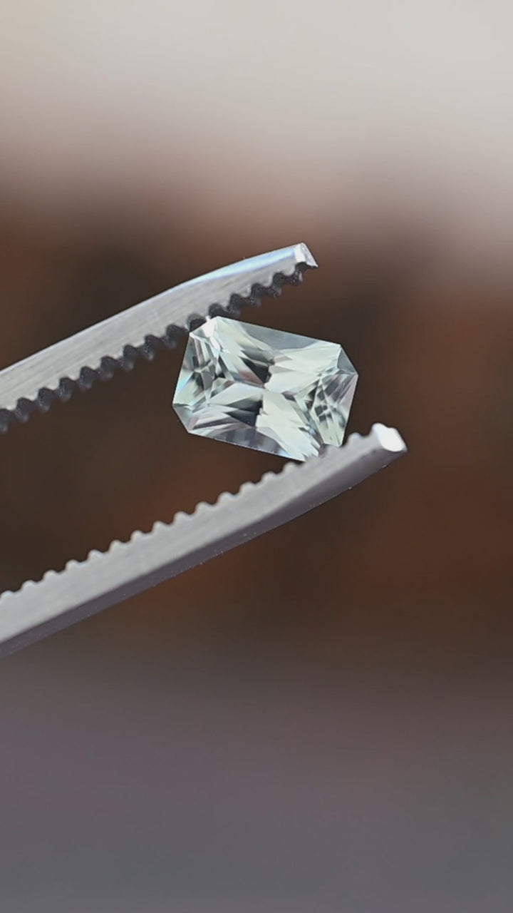 Discover this untreated 0.695 carat Montana sapphire as its precision radiant cut reveals soft seafoam green color and elegant natural brilliance from every angle.