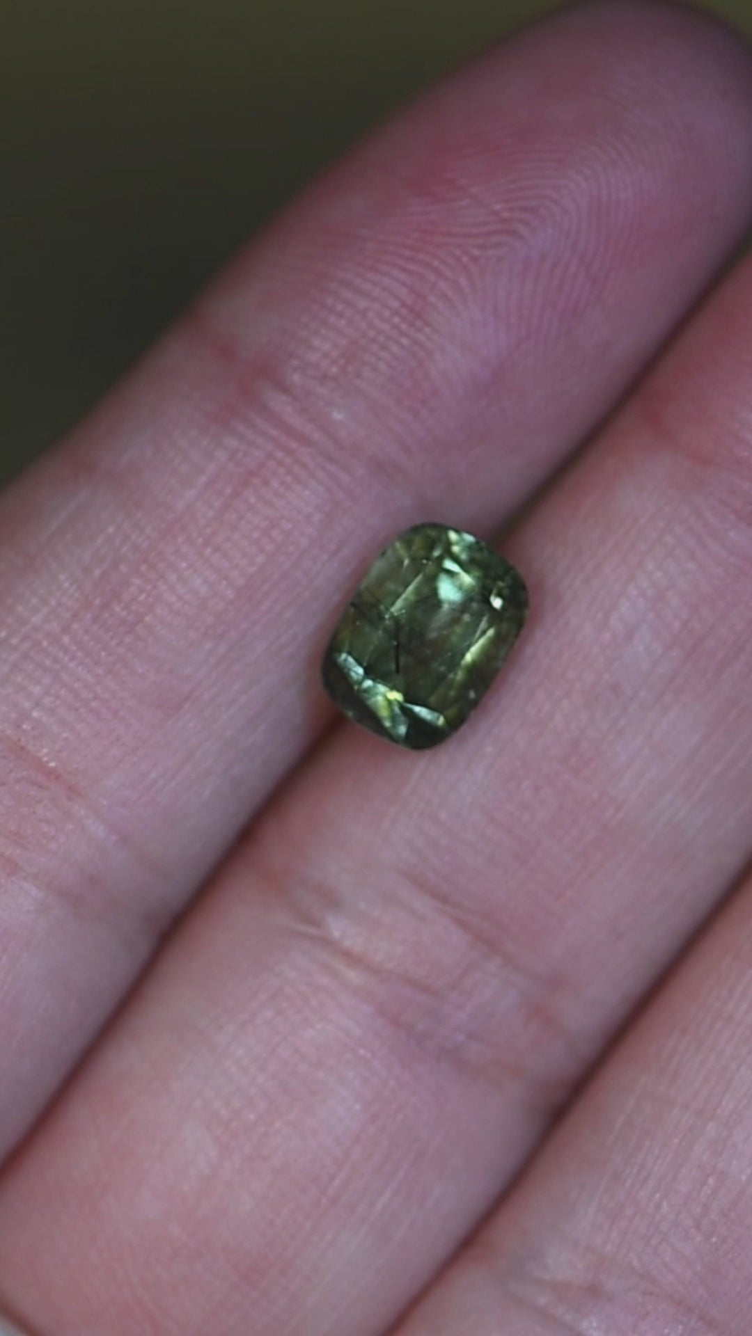 Experience this natural untreated Pakistan peridot in hand as its soft ombre green tones, elegant cushion mix cut, and intricate crystal inclusions become visible from every angle.