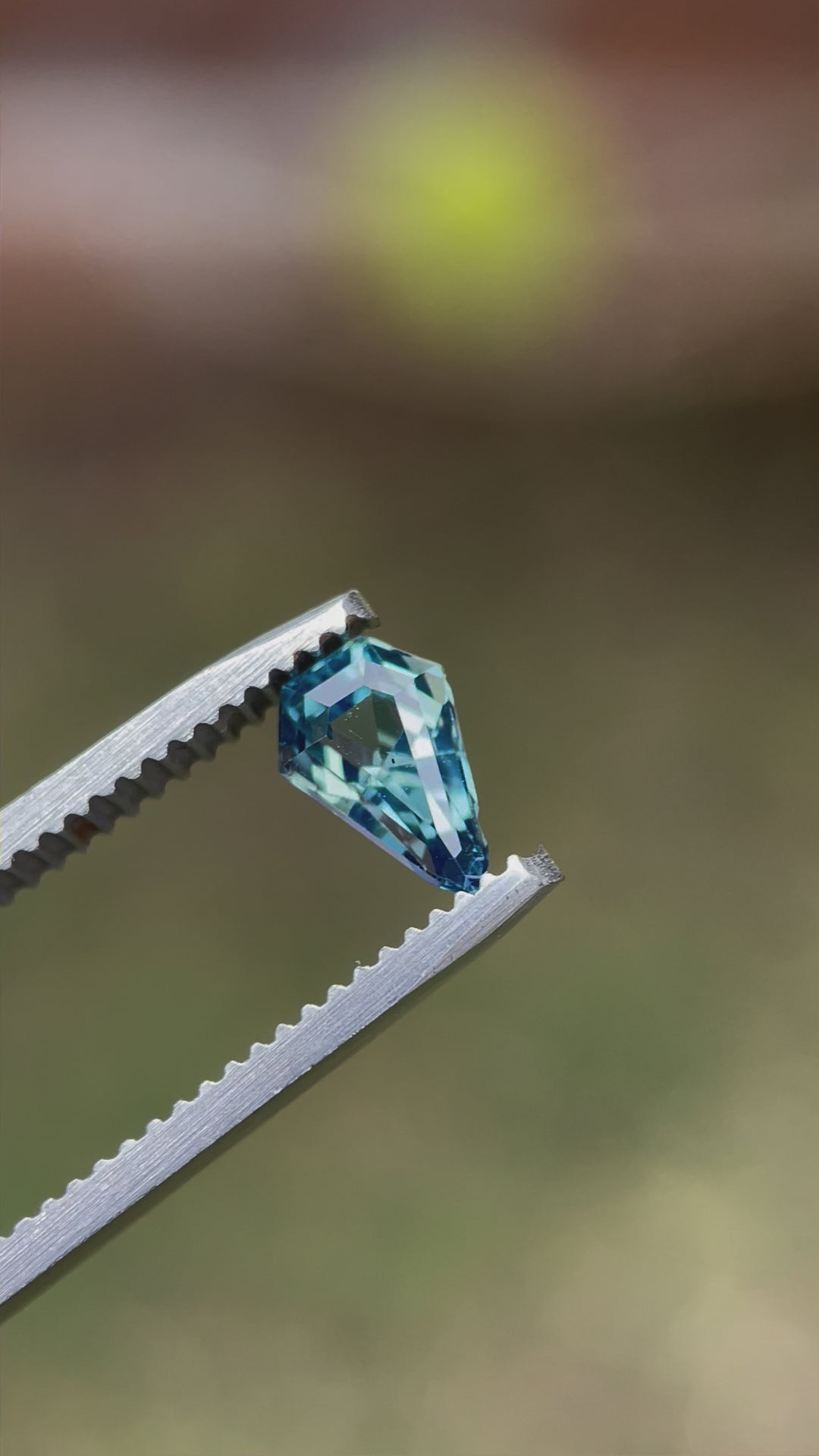 A video showcasing a 1.13-carat opalescent denim blue sapphire in motion, revealing the gem's step cut shield facets and brilliance as it is rotated. Captured to highlight the gem's exceptional quality and no-heat treatment.