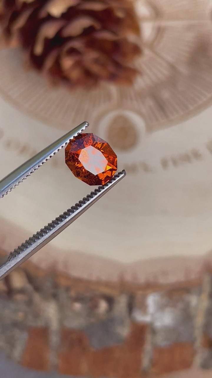 Close-up video highlighting the intricate details and fiery color of a 1.61-carat Hessonite Garnet oval cut.