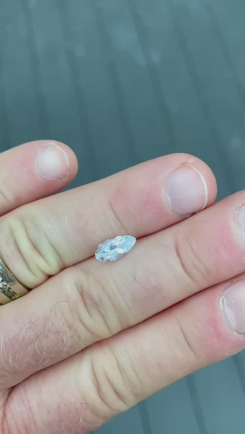 Captivating video presentation of a light sage green sapphire, focusing on its unique 1.42 carat weight and custom pear shape from Sri Lanka. This video highlights the gemstone's natural beauty and the absence of any heat treatment.