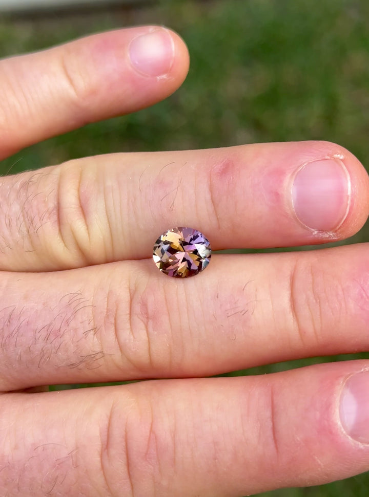 Hand-held video of untreated Tanzanite gemstone from Merelani Hills showing vibrant fancy hues and exceptional brilliance in roval cut
