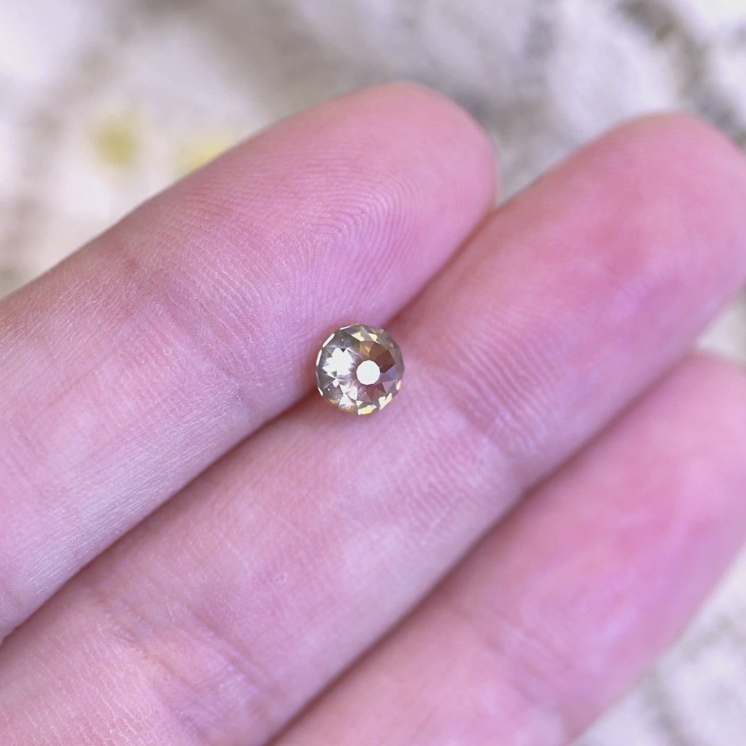 Rotating loose rosy champagne fancy brown Mughal cut diamond from South Africa, revealing its brilliance and subtle color shifts in changing light.