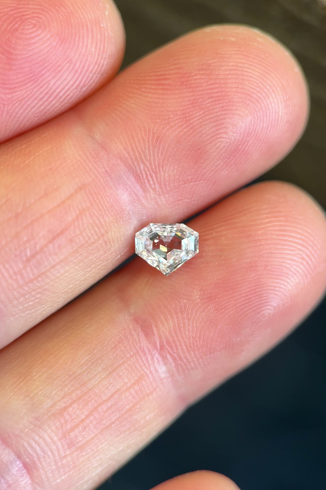 Video of a 1.01 carat E color SI1 clarity diamond from Gahcho Kué, Canada, in hand to show brilliance, clarity, and the precision of its shield step cut. Natural, untreated, and ethically sourced.
