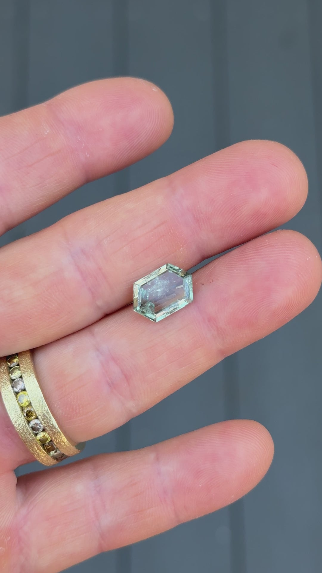 Natural lighting video of teal green Montana sapphire, 3.80 carats, in hexagon step cut with no heat treatment