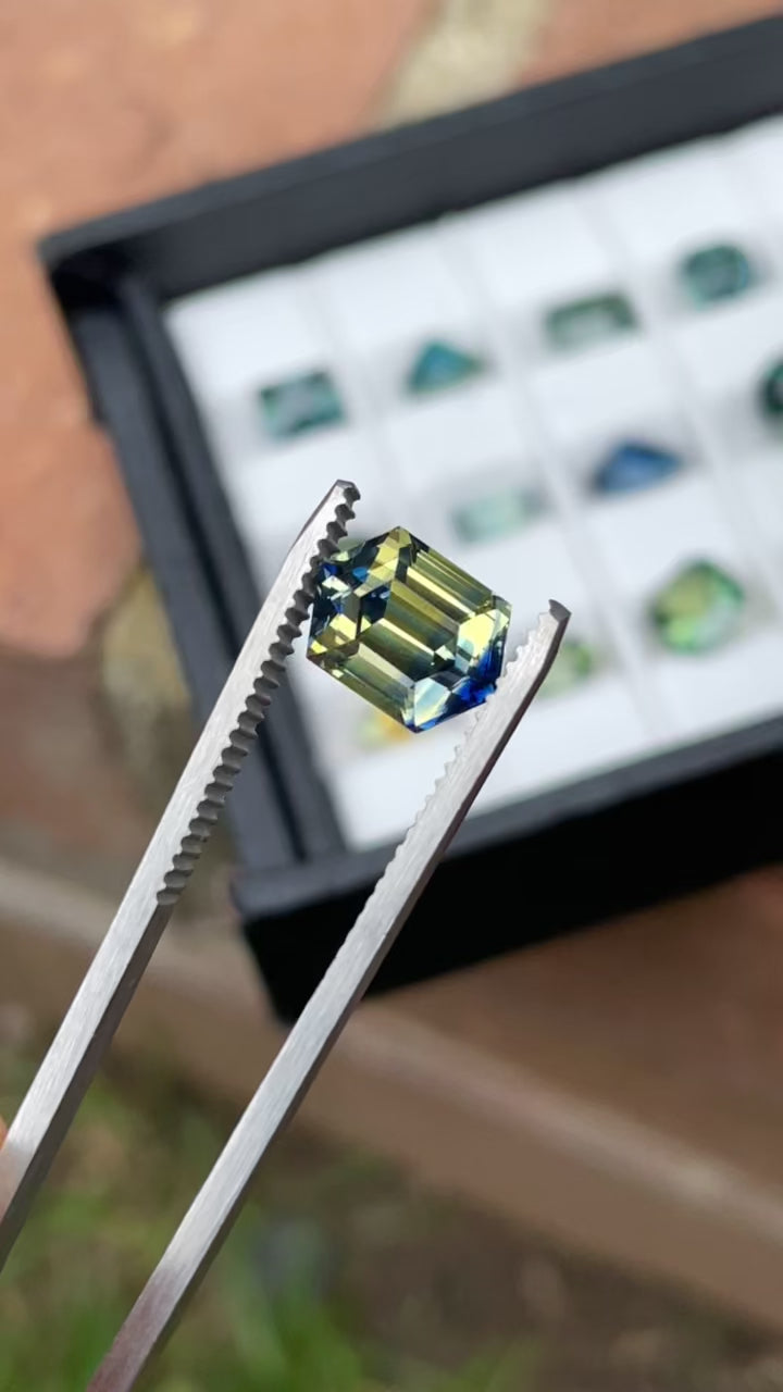 Rotating video of a 4.13 carat Parti Sapphire from Sri Lanka, highlighting sharp blue and yellow zones in a hexagonal step cut.