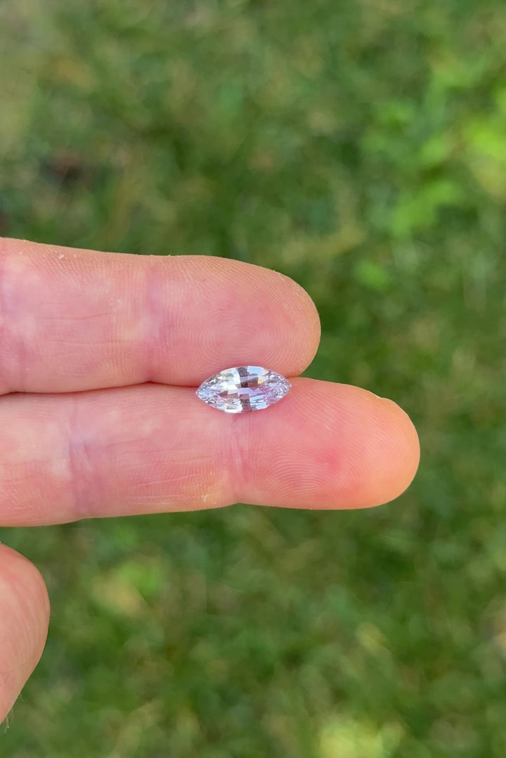 Macro close-up video of natural 2.68CT marquise mixed cut sapphire from Sakaraha, Madagascar, revealing brilliance, clarity, and silvery lilac shimmer with every movement.