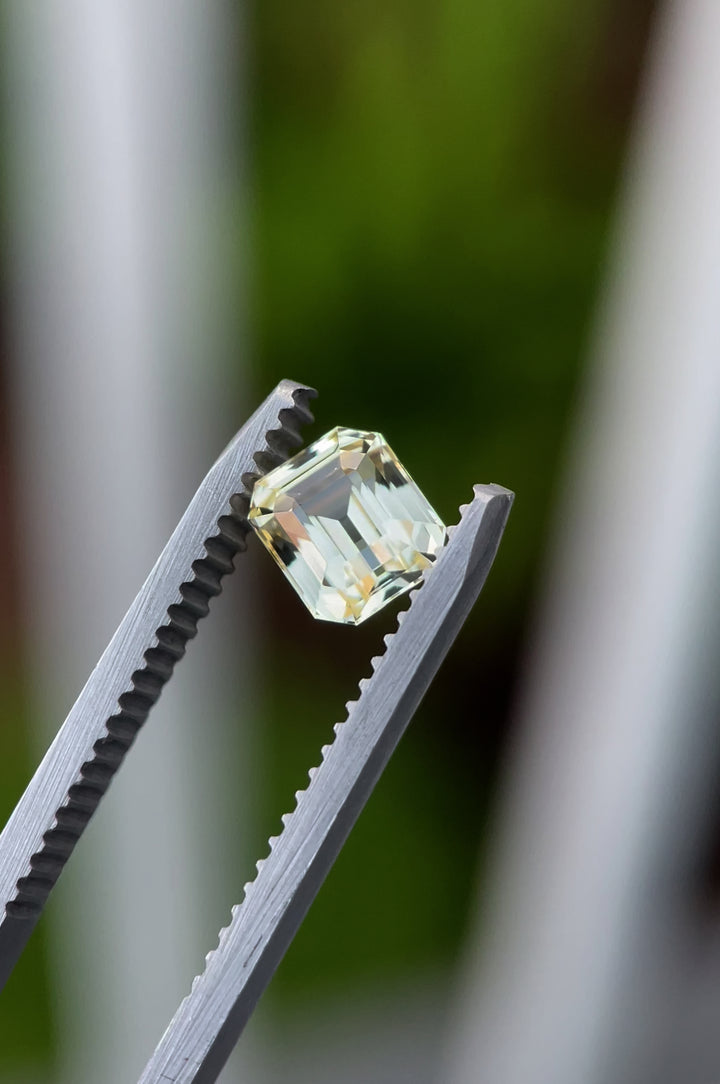 A close-up video of the pastel canary yellow sapphire, showcasing its 1.43-carat weight, octagonal step cut, and pristine clarity. The gem sparkles vividly as light dances across its facets, emphasizing its radiant pastel yellow tone.
