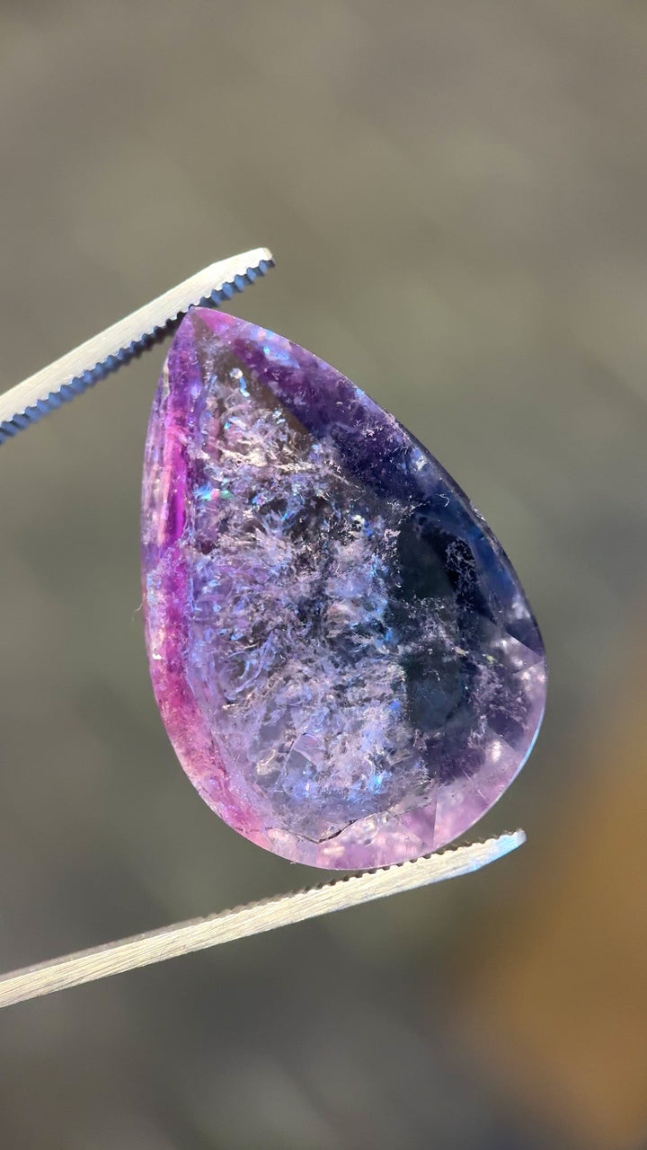 Rotating video of 46.80 carat pear rose cut tourmaline from Paprok Mine, Afghanistan, showing natural color transitions from purple to pink and blue under soft lighting
