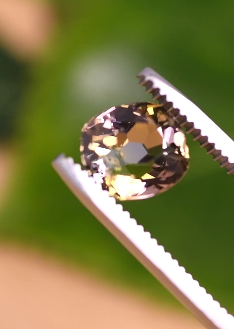 Video of a 3.27CT untreated tanzanite slowly rotated to show its custom modified old mine cut, revealing shifting purple, pink, and peach tones and antique-style faceting from Merelani Hills Tanzania
