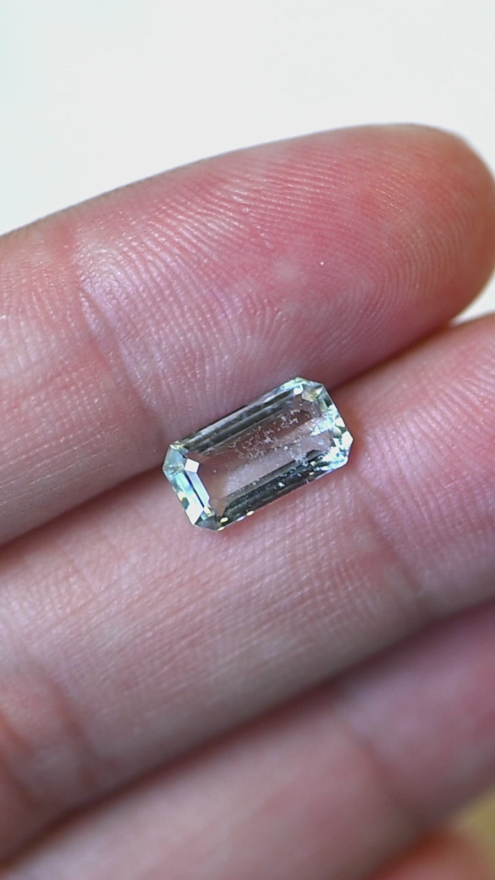 View this untreated 1.55 carat Colorado aquamarine in natural light as its custom octagonal step cut reveals crisp reflections, exceptional transparency, and a soft light medium blue color