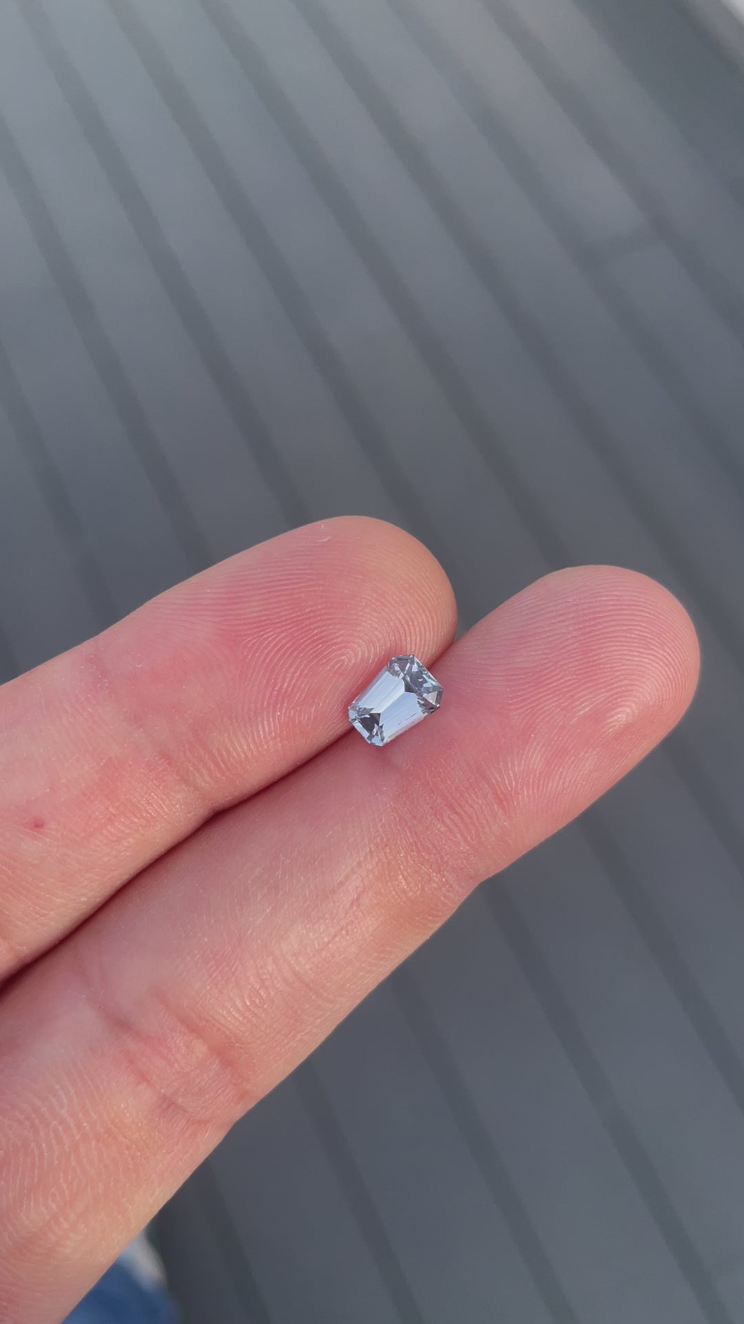 Close-up video of a pale blue 1.64 carat sapphire from Sri Lanka, showing the intricate facets and cool, soft blue tones as it moves under light, showcasing the brilliance of the fancy mixed cut.