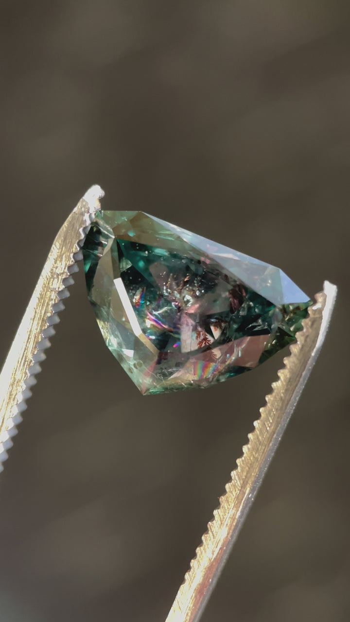 A close-up video of a stunning 7.06-carat sapphire in a modified shield brilliant cut, ethically sourced from Montana with no heat treatment.