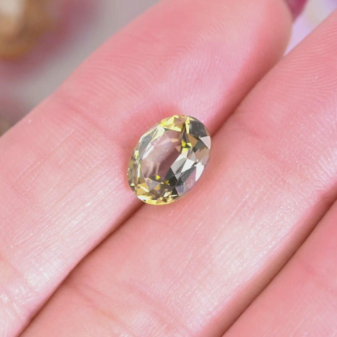 Close up video of 2.77ct oval Tanzanite displaying green and gold hues faceting detail and natural gemstone clarity from Tanzania