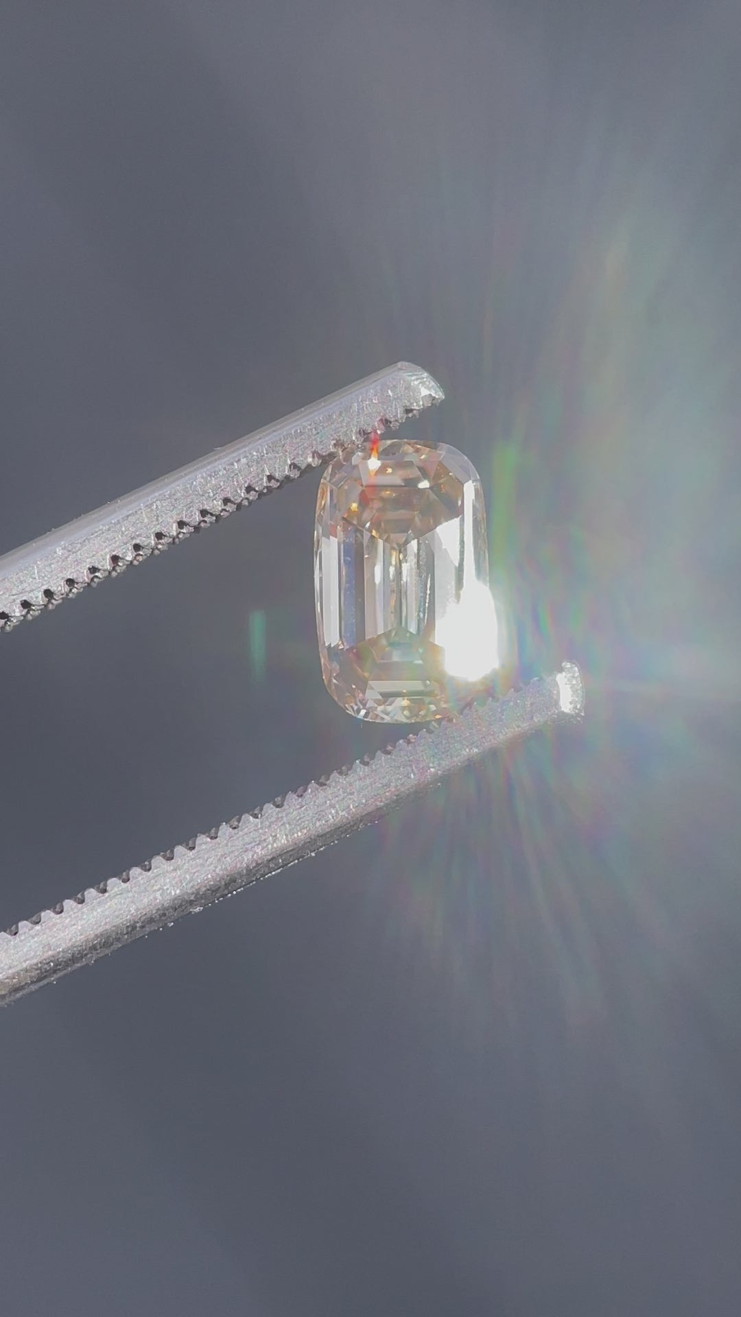 A stunning 1.03-carat champagne diamond with a light fancy yellowish brown hue, showcased in a close-up view to highlight its antique-style elongated step cut cushion shape.