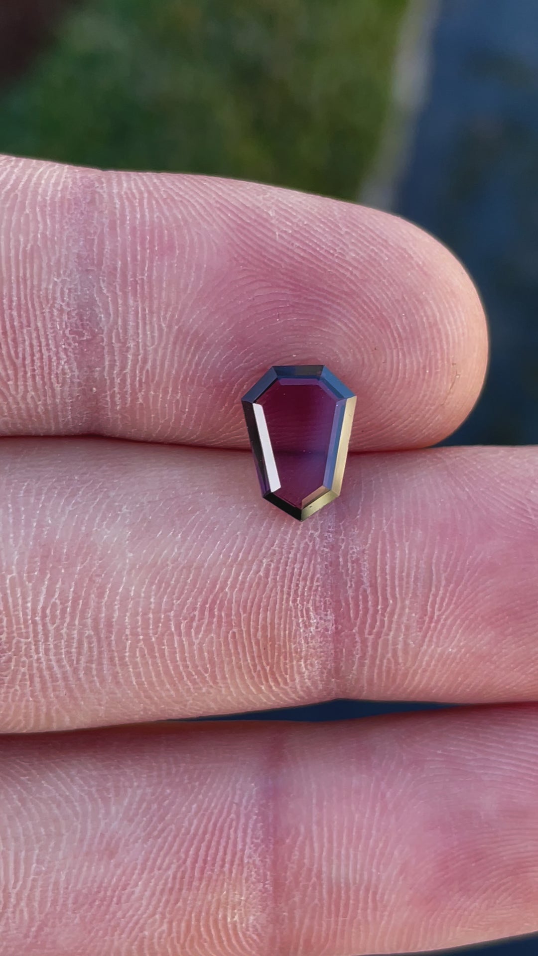 360-degree video of a 2.05 carat spinel gemstone from Sri Lanka, highlighting its shield step cut, vibrant red-purple hues, and natural untreated beauty.