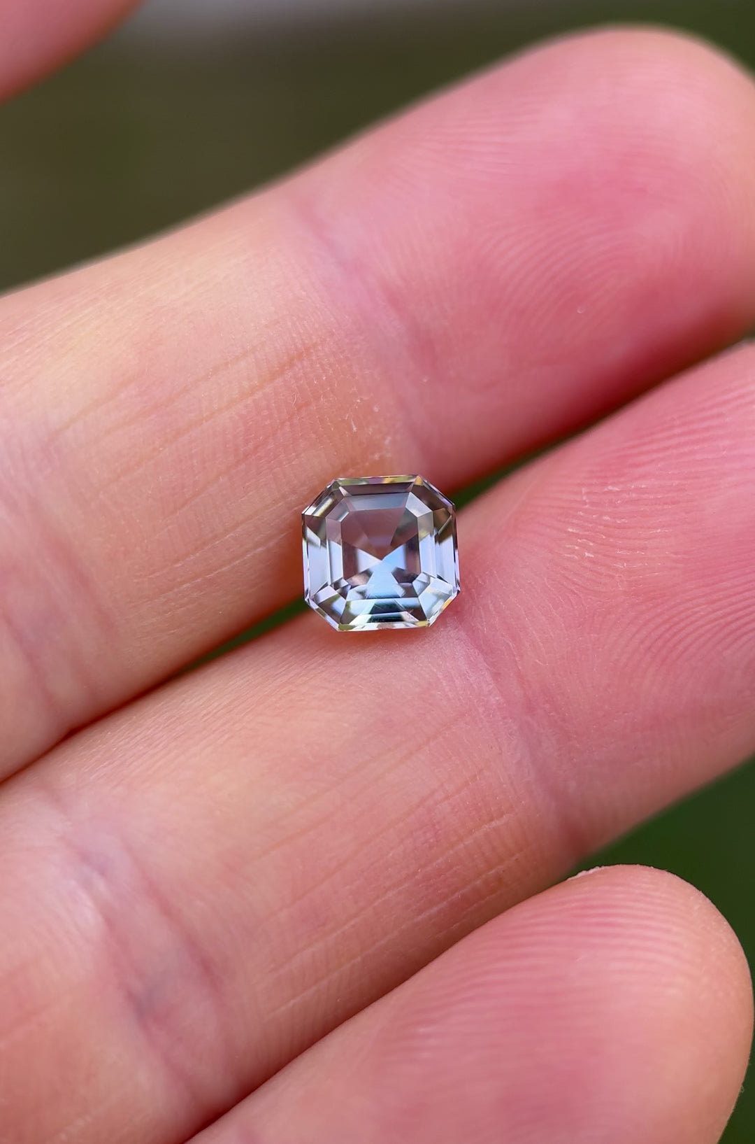 Detailed macro video of 1.99ct Tanzanite in custom Asscher cut with pastel, teal, and lavender reflections