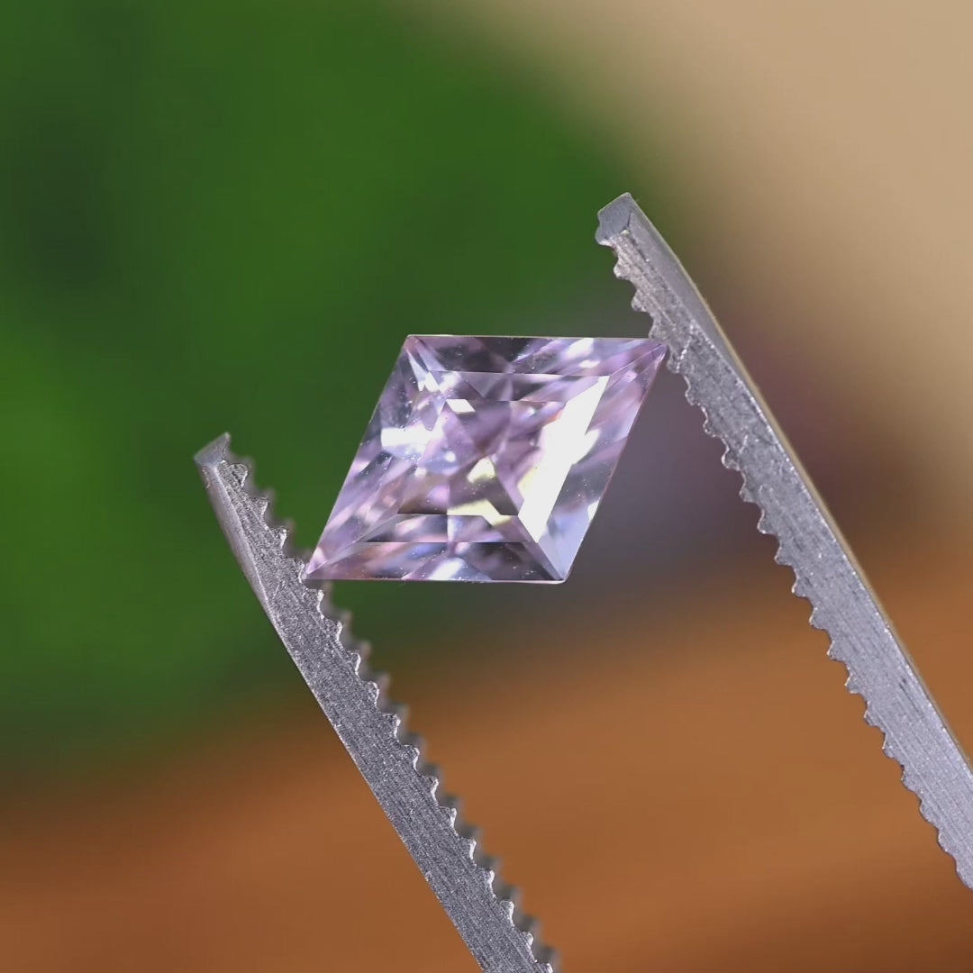Rotating loose blush pink sapphire from Sakaraha Madagascar showing the brilliance and soft color shift of the kite step cut as it moves in light.