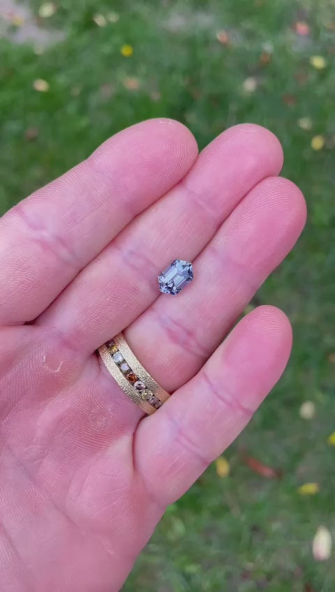 n-depth look at a hexagon step cut Tanzanite weighing 1.79 carats from Tanzania, displaying its vibrant mermaid teal, purple, and blue colors and exquisite gemstone cut.
