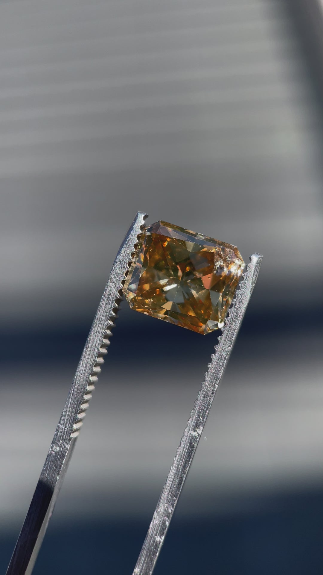 360-degree video of a 3.68-carat radiant cut champagne diamond, capturing its sparkling brilliance and brown-yellow hue in motion.